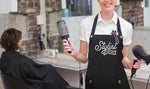 Hair Stylist wearing black silver apron from Trendy Salon Aprons