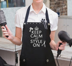 Hair Stylist wearing apron saying KEEP CALM & STYLE ON from Trendy Salon Aprons