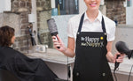 Hair Stylist wearing Apron saying BE HAPPY NOT NAPPY from Trendy Salon Aprons