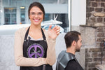 Hair Stylist wearing apron with peace sign from Trendy Salon Aprons